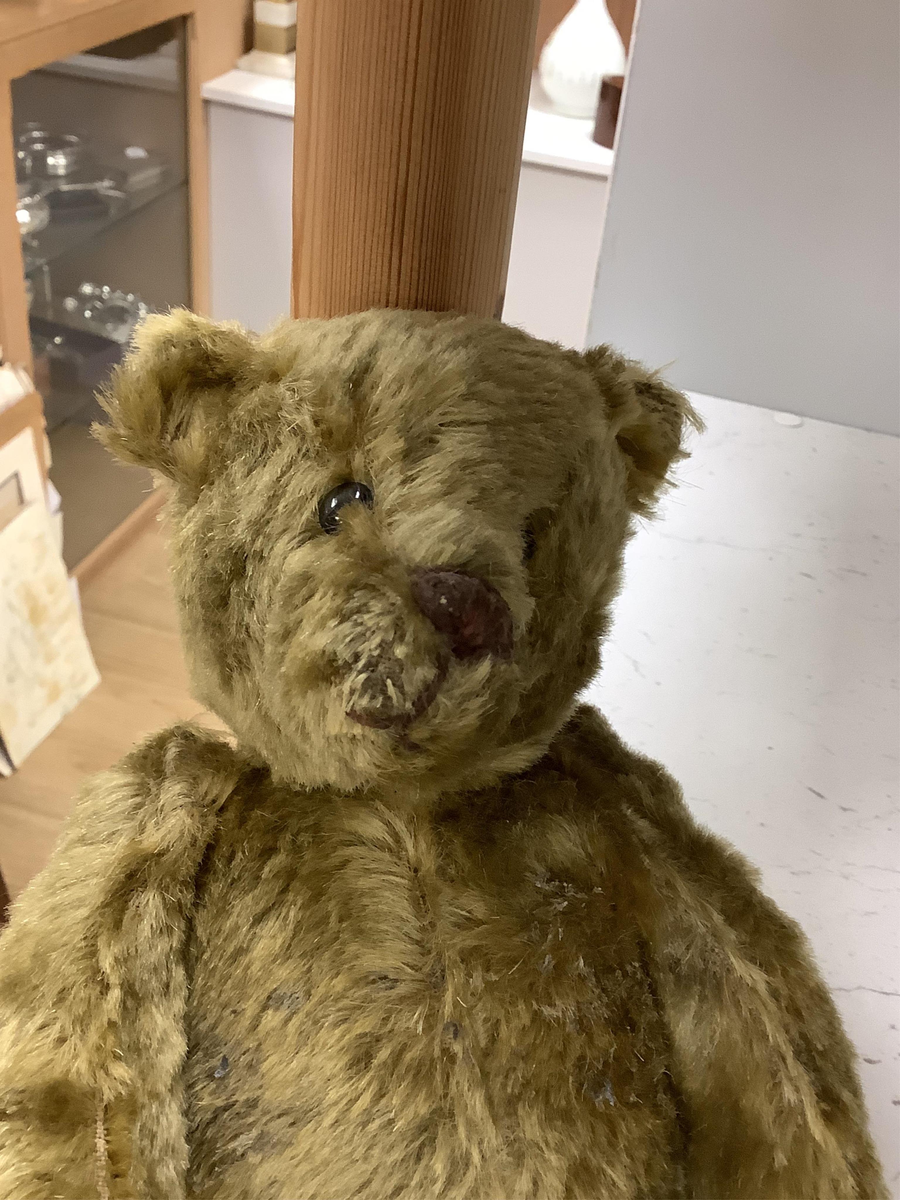 An early 20th century German hump backed plush teddy bear and three others, German teddy 30cm high. Condition - the German teddy has a short split on the back seam and glue on the front leg that needs removing and plush